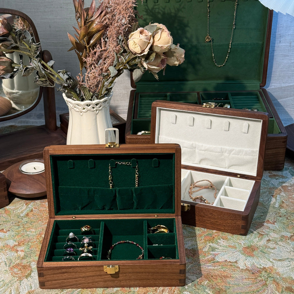 Wooden jewelry box with jewelry on a floral-patterned surface