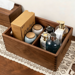 Wooden storage box with decorative items on a lace tablecloth