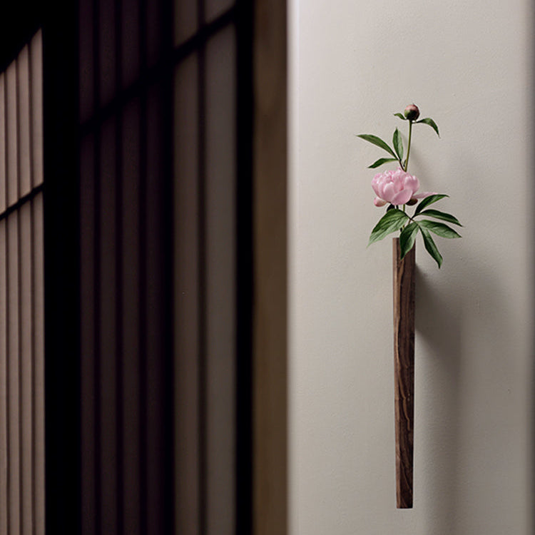 Flora black walnut wall vase hanging on living room wall