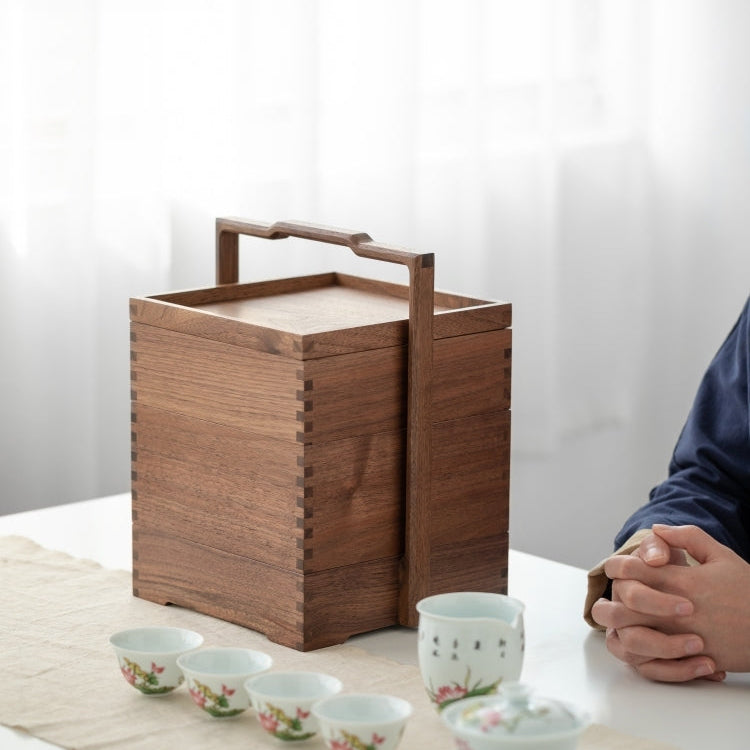 Side view of walnut tea storage box with metal handle