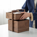 Tea storage box with handle opened to display compartments
