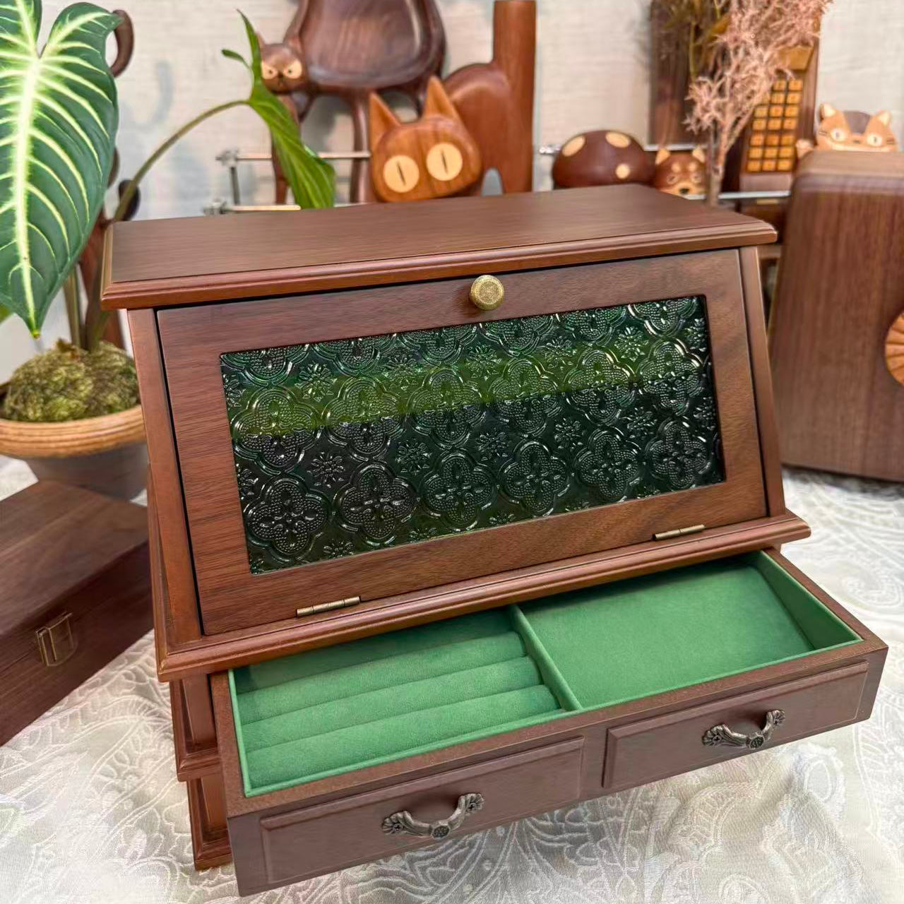 Wooden jewelry box with green interior, decorative items in the background